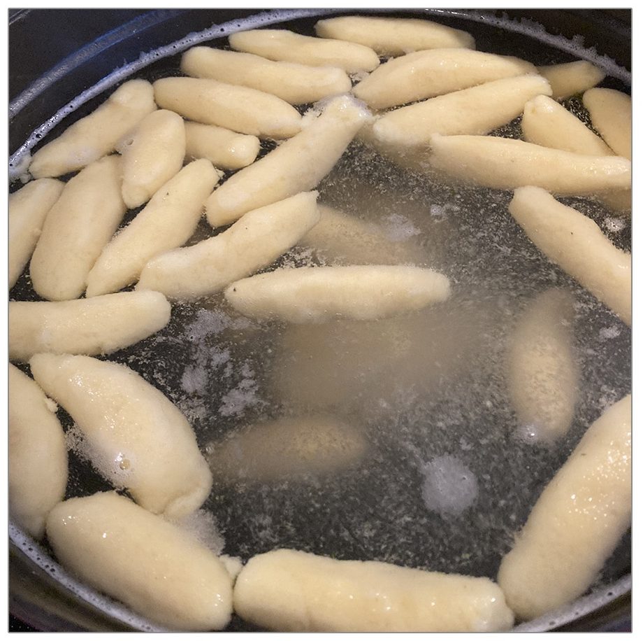 Schupfnudeln aus Kartoffelteig schwimmen im kochenden Salzwasser